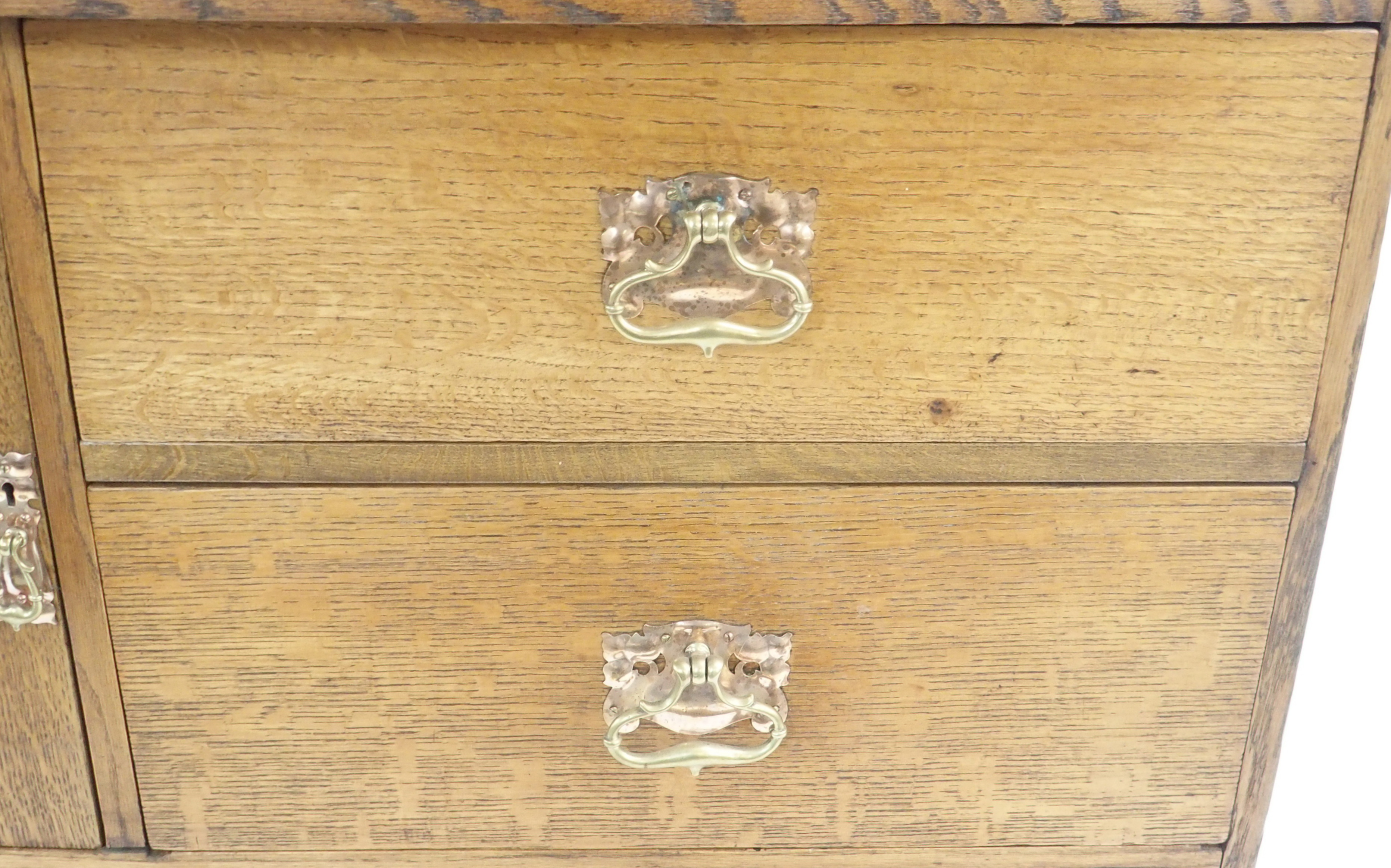 AN ARTS AND CRAFTS OAK DRESSER with open shelves, flanked by embossed inset brass panels and - Image 7 of 15