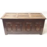 AN OAK 18TH CENTURY STYLE COFFER the hinged panelled top above four carved and inlaid panels