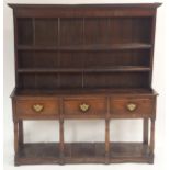 A 19TH CENTURY OAK DRESSER the base with three drawers above four baluster tapering legs, joined