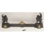 A 19TH CENTURY CAST STEEL AND BRASS FIREPLACE FENDER in three sections, modelled with winged