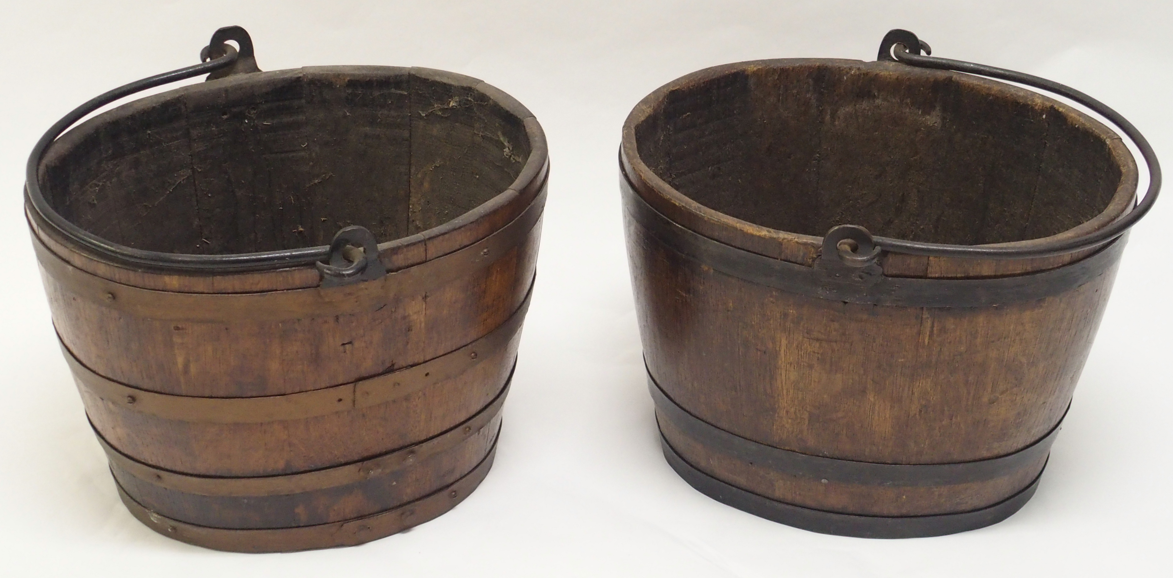 TWO OAK STAVED METAL BOUND LOG BINS each with wrought iron swing handles, 29.5cm high and 41cm