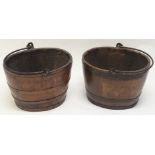 TWO OAK STAVED METAL BOUND LOG BINS each with wrought iron swing handles, 29.5cm high and 41cm