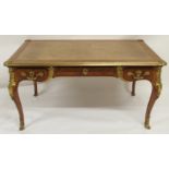 A LOUIS XV STYLE FRUITWOOD AND GILT-METAL BUREAU PLAT with leather skiver above three drawers and