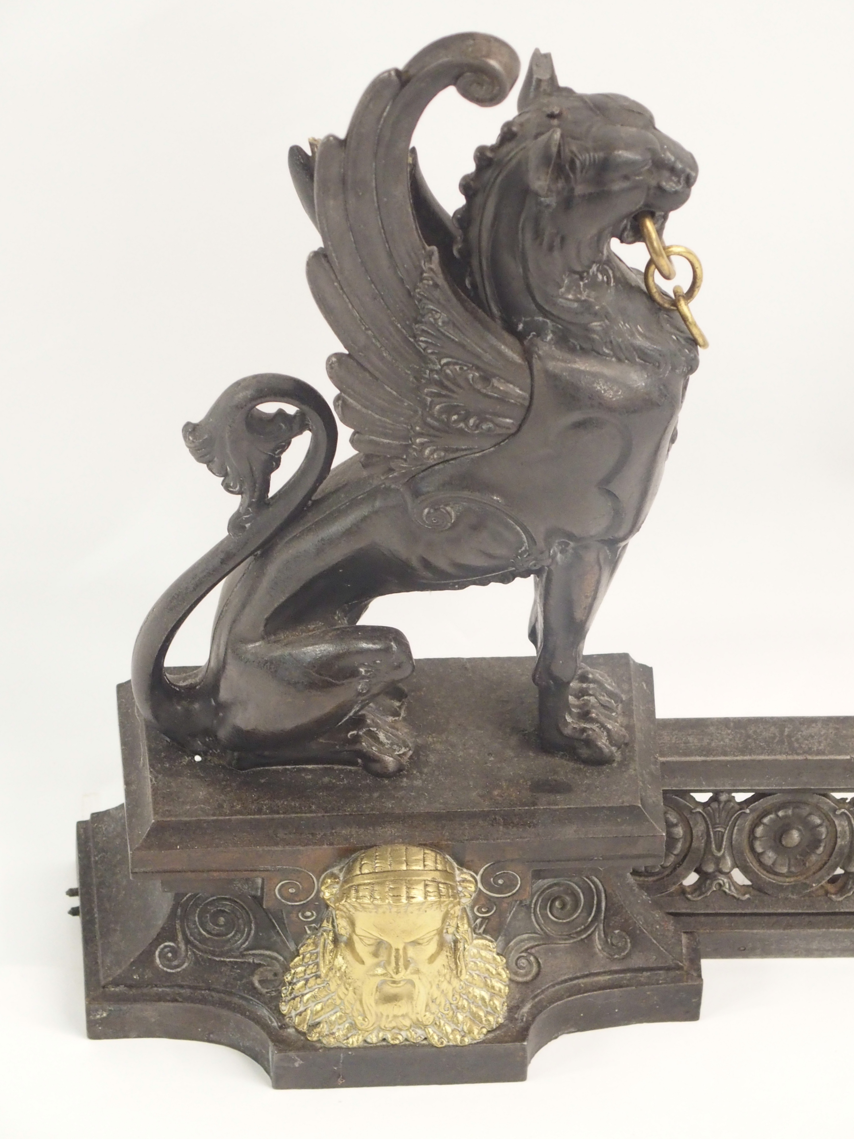 A 19TH CENTURY CAST STEEL AND BRASS FIREPLACE FENDER in three sections, modelled with winged - Image 4 of 15