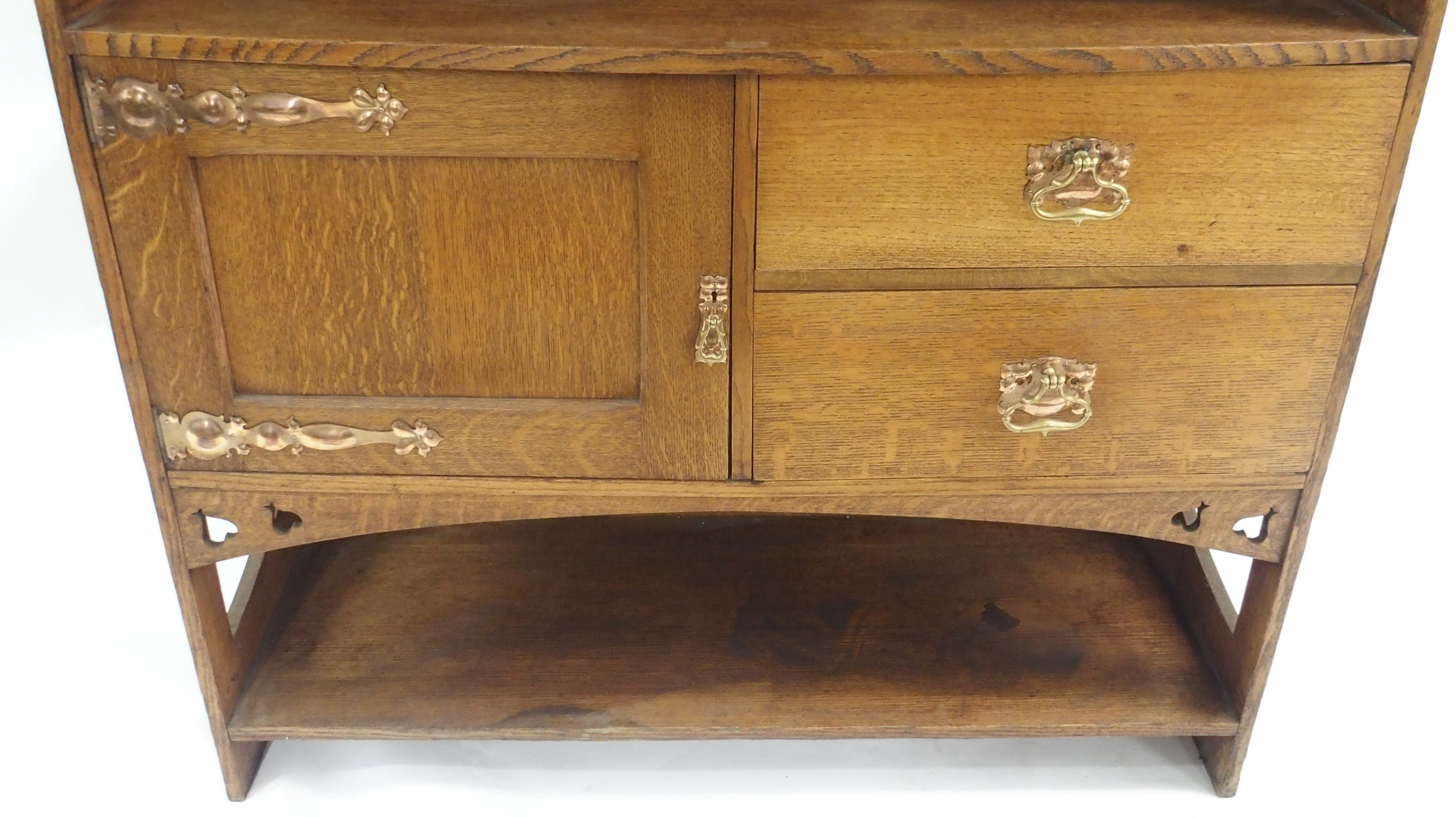 AN ARTS AND CRAFTS OAK DRESSER with open shelves, flanked by embossed inset brass panels and - Image 5 of 15