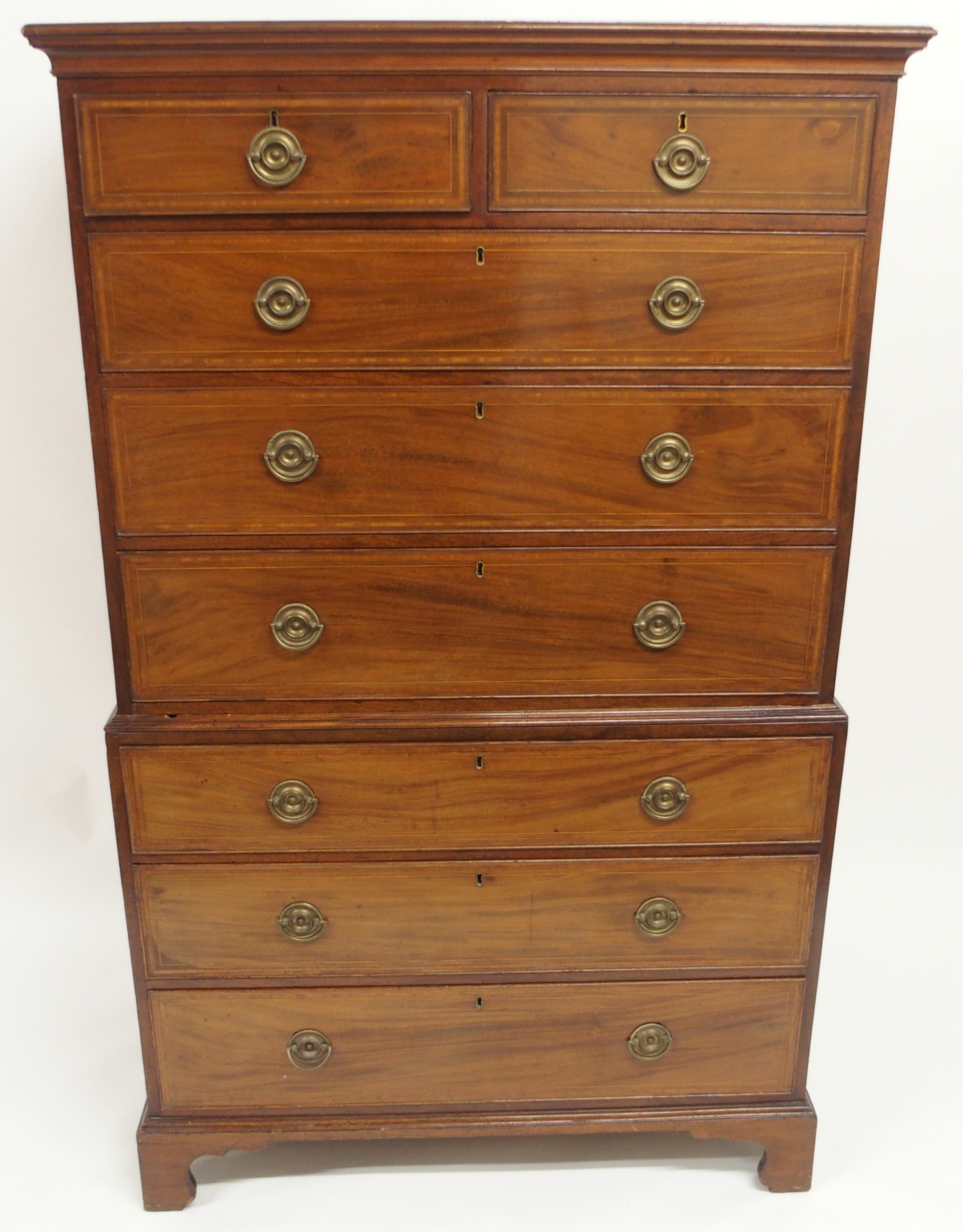 A MAHOGANY AND SATINWOOD CROSS BANDED CHEST ON CHEST with two over three graduating drawers on three