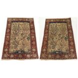 A PAIR OF LIGHT GROUND EASTERN RUGS with a field of blossom trees, ducks, cockerels and other