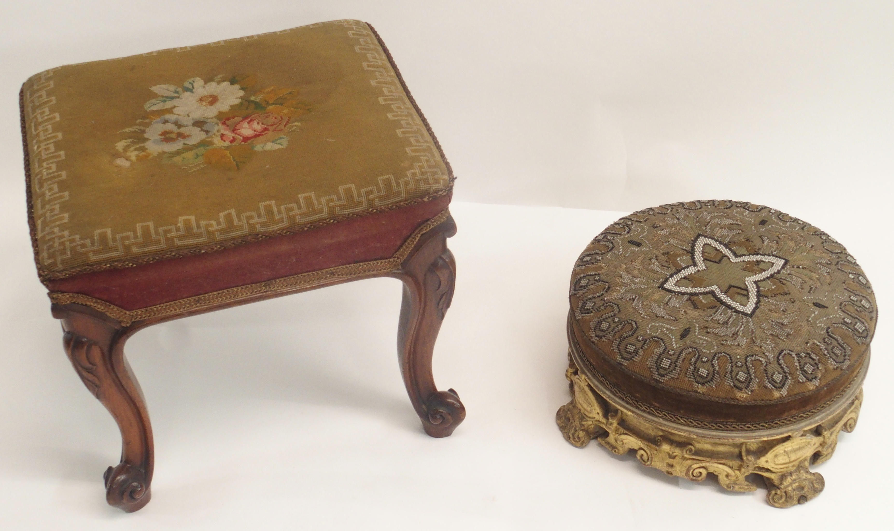 A MID 19TH CENTURY GILTWOOD AND GESSO FOOT STOOL the beadwork cover on a gilt scroll frame, 35cm