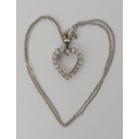 A white metal diamond set heart shaped pendant, dimensions 2.4cm x 1.8cm, set with estimated