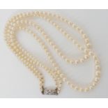 A double string of Mikimoto pearls with a silver Mikimoto stamped clasp, shortest length 43cm,