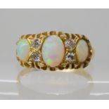 An 18ct gold opal and diamond ring, size M1/2, weight 2.9gms Condition Report: