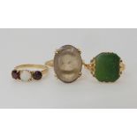 A 10k gold ring set with a green gemstone size M1/2, a 9ct smoky quartz style ring size N1/2 and a