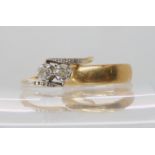 An 18ct gold twin stone diamond ring of estimated approx combined 0.25cts with diamond accents to