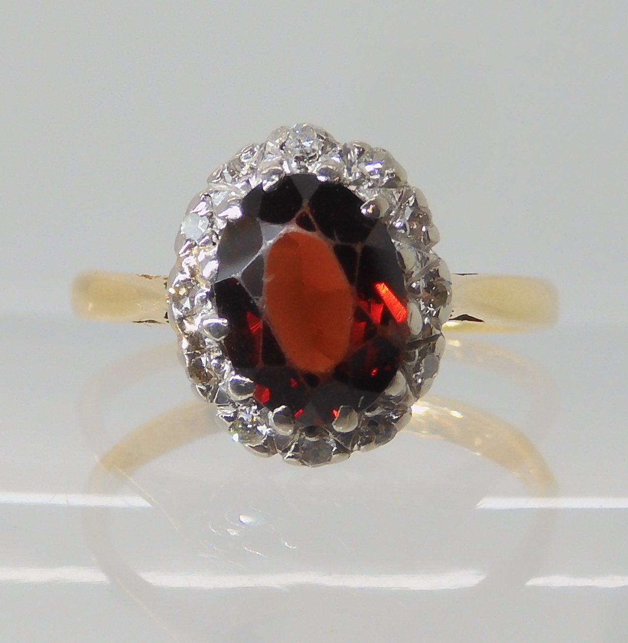 An 18ct gold garnet and diamond ring size L, weight 2.9gms Condition Report: Available upon request