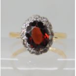 An 18ct gold garnet and diamond ring size L, weight 2.9gms Condition Report: Available upon request