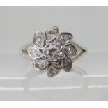 An 18ct white gold diamond flower cluster ring, size J, weight 4.3gms Condition Report: Available