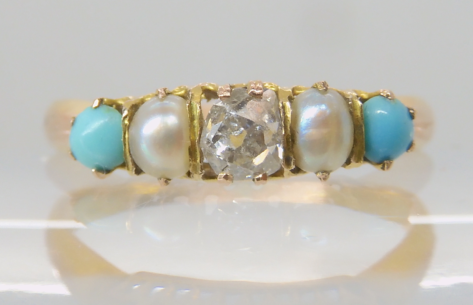 A bright yellow metal vintage ring set with an old cut diamond of approx 0.17cts, pearls and