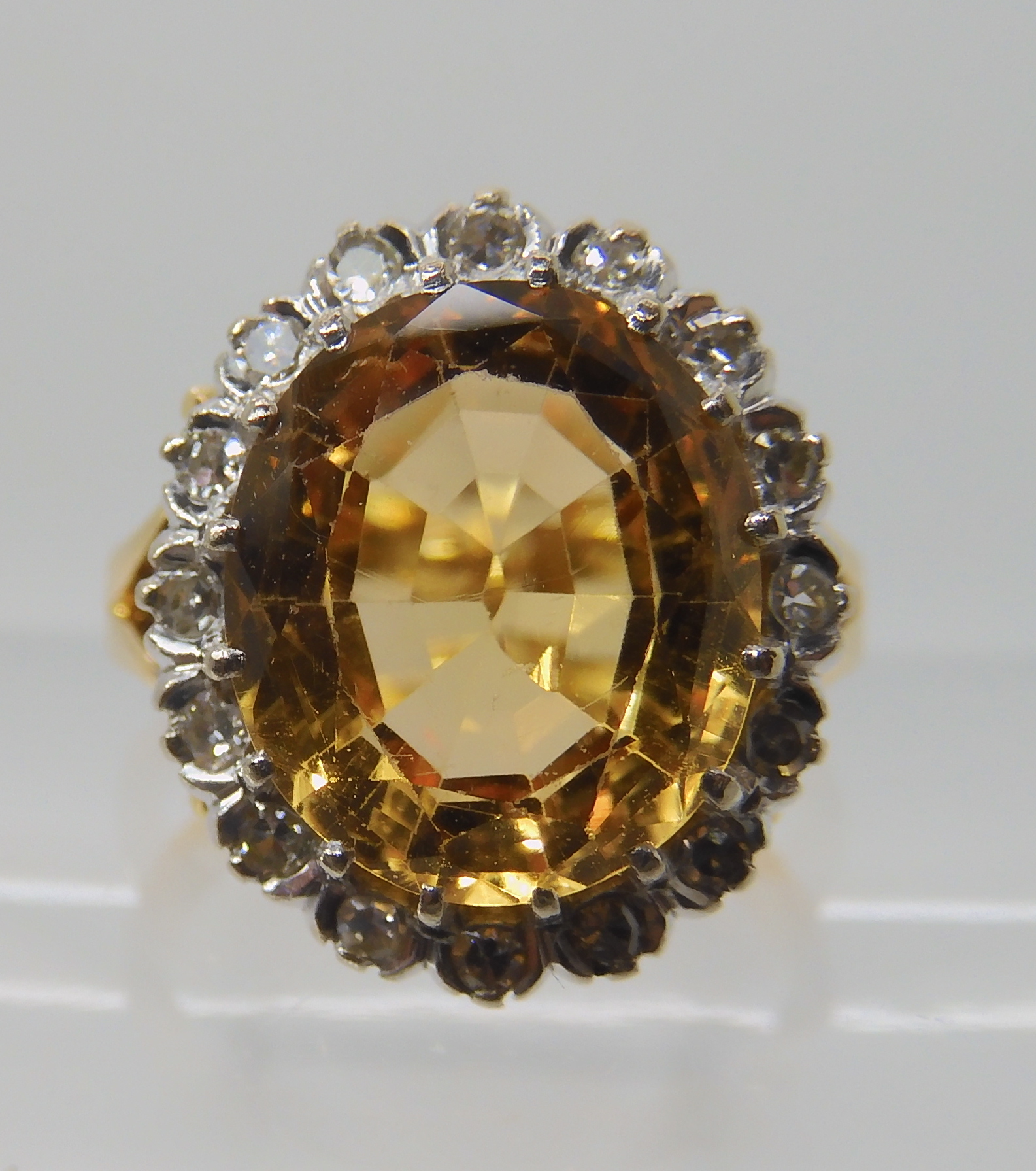 A bright yellow metal ring set with a yellow topaz surrounded with a ring of eight cut diamonds, - Image 4 of 4