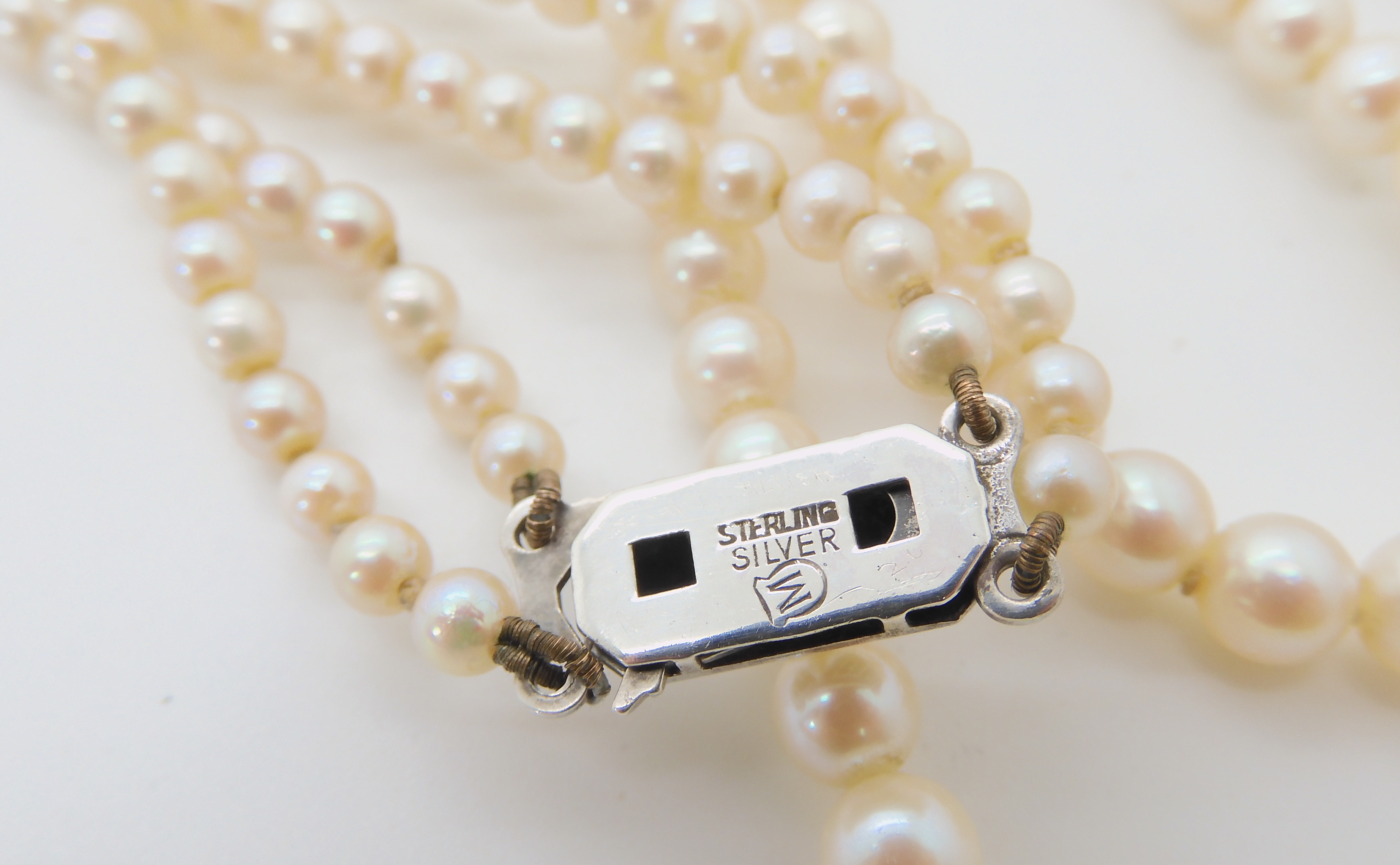 A double string of Mikimoto pearls with a silver Mikimoto stamped clasp, shortest length 43cm, - Image 2 of 2