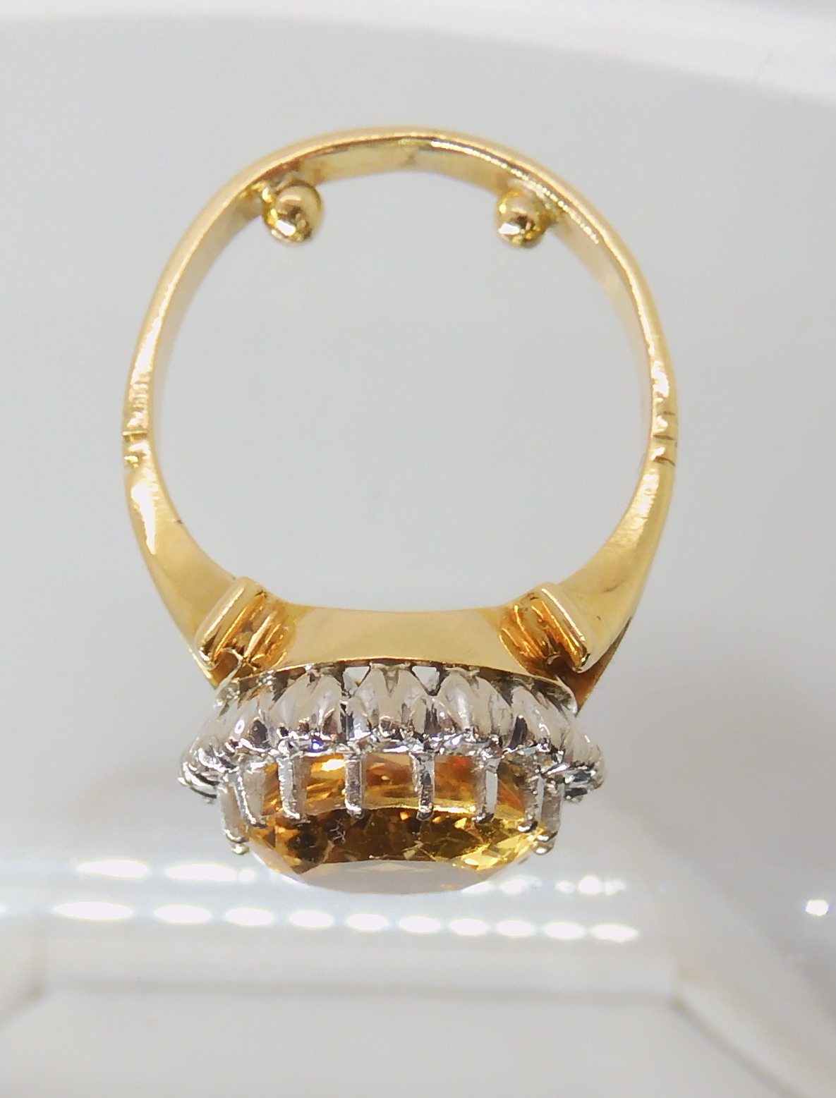A bright yellow metal ring set with a yellow topaz surrounded with a ring of eight cut diamonds, - Image 3 of 4