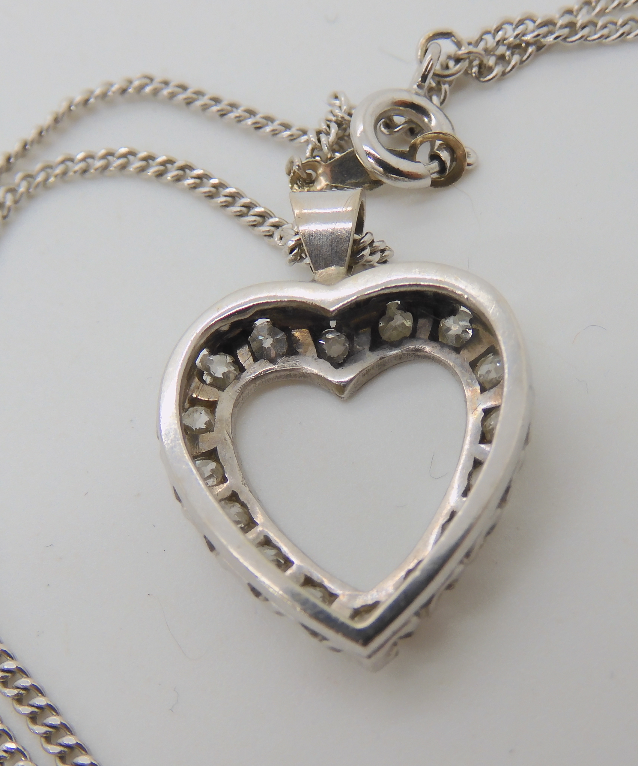 A white metal diamond set heart shaped pendant, dimensions 2.4cm x 1.8cm, set with estimated - Image 3 of 3