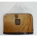 An animal hide wallet bearing the Ugandan coat of arms, "For God and Country" containing the