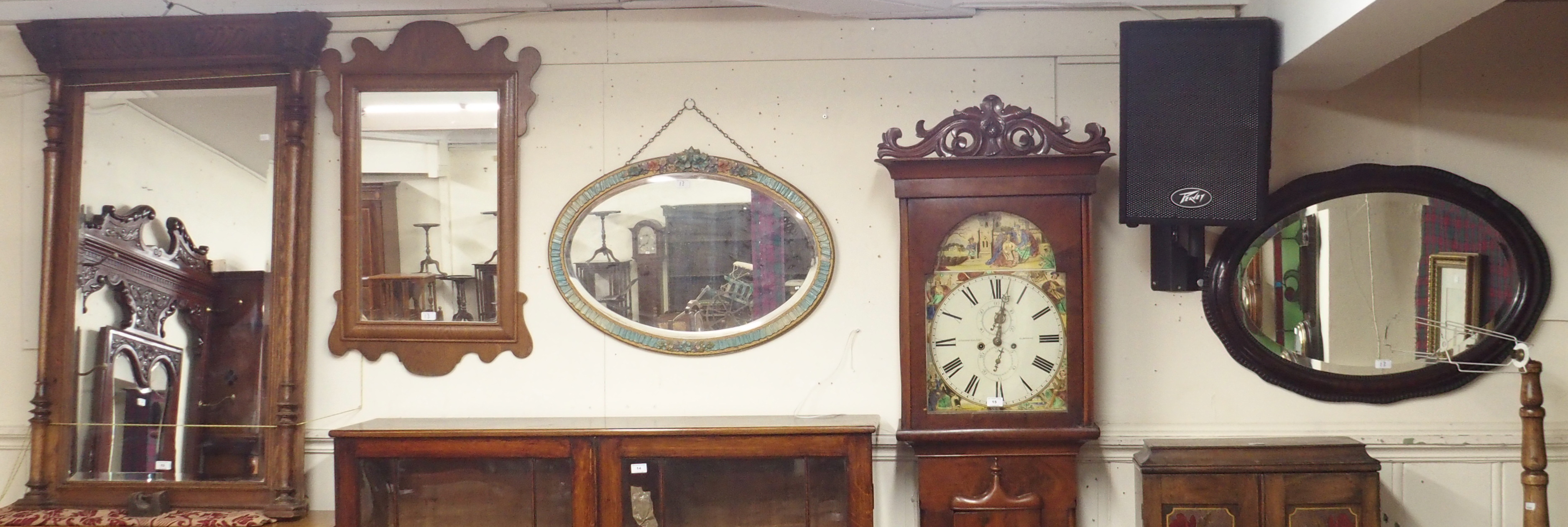 A carved oak overmantle mirror, two oval wall mirrors and a Georgian style oak wall mirror(4)