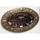 A brass Arts and Crafts oval mirror, 38cm x 60cm Condition Report: Available upon request
