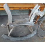 A wooden rocking horse made from a cart wheel Condition Report: Available upon request