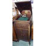 An HMV gramophone in a mahogany cabinet with records Condition Report: Available upon request