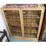 A light oak bookcase with leaded glass doors, 118cm high x 108cm wide Condition Report: Available