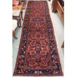 A red ground Karejh runner with allover geometric design, 403cm x 117cm Condition Report: