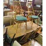 A Ercol dining table, 72cm high x 150cm wide x 77cm wide with two Goldsmith carvers and four