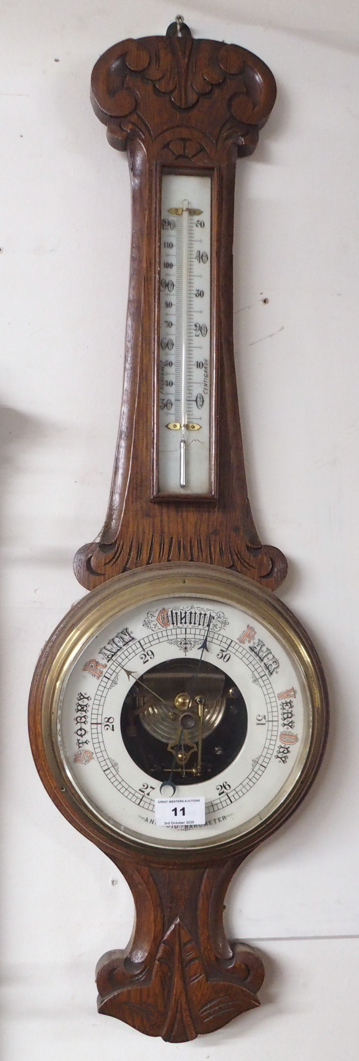 A carved oak barometer Condition Report: Available upon request