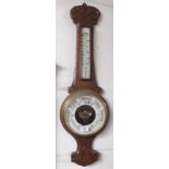 A carved oak barometer Condition Report: Available upon request