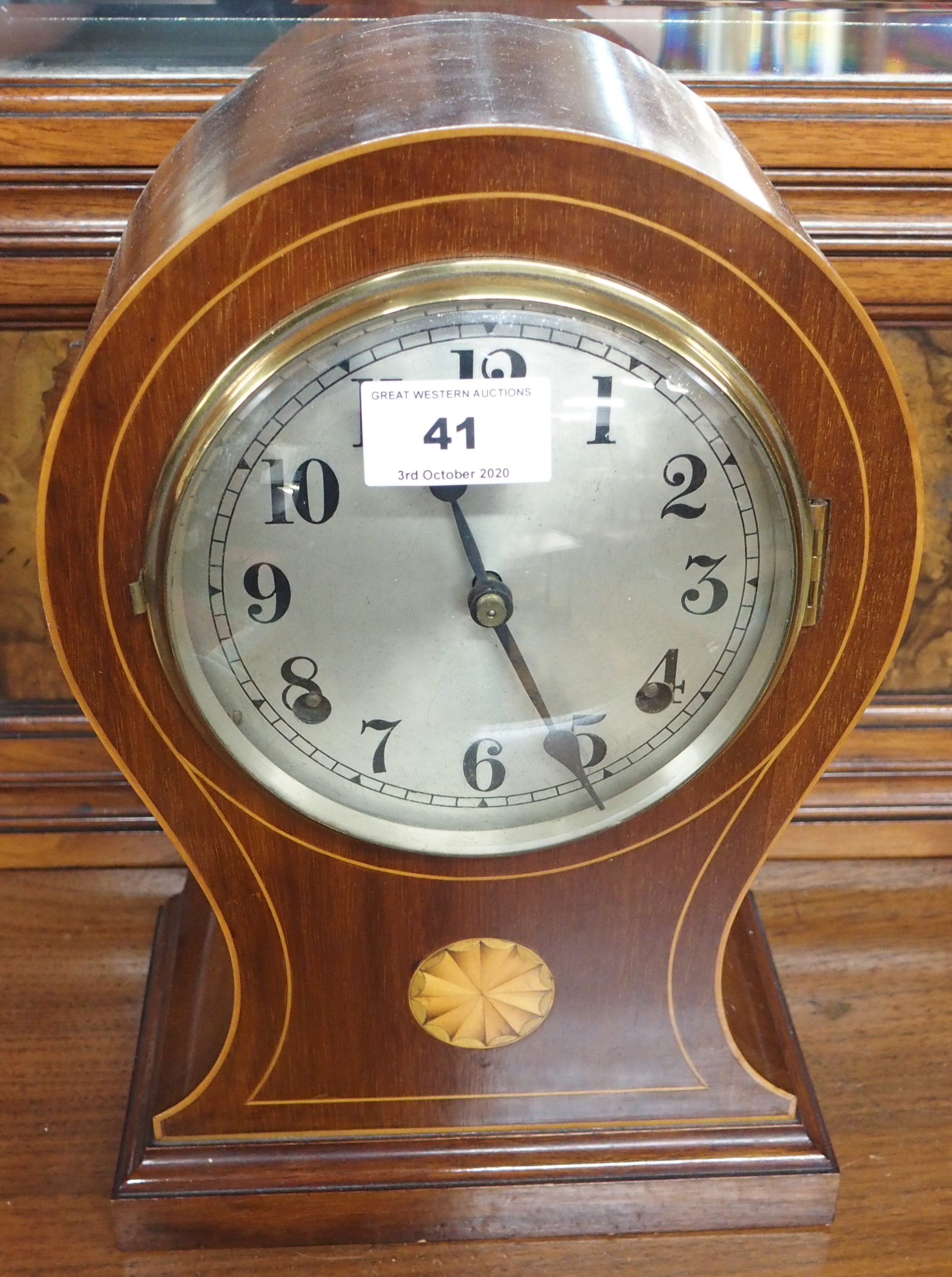 A mahogany inlaid mantle clock and an oak barometer (2) Condition Report: Available upon request