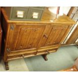 A carved oak buffet with two doors over two drawers, 95cm high x 107cm wide Condition Report: