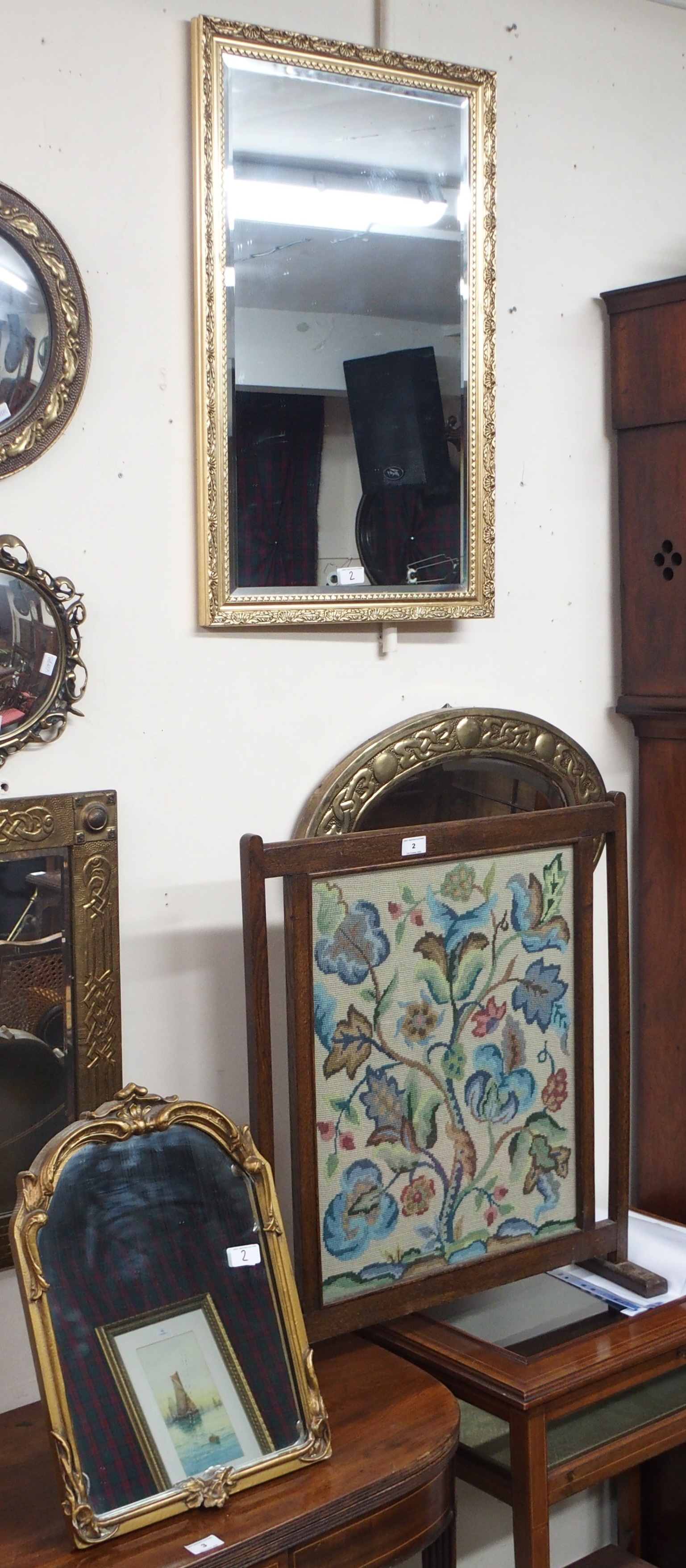An oak framed tapestry firescreen and two gilt mirrors (3) Condition Report: Available upon request