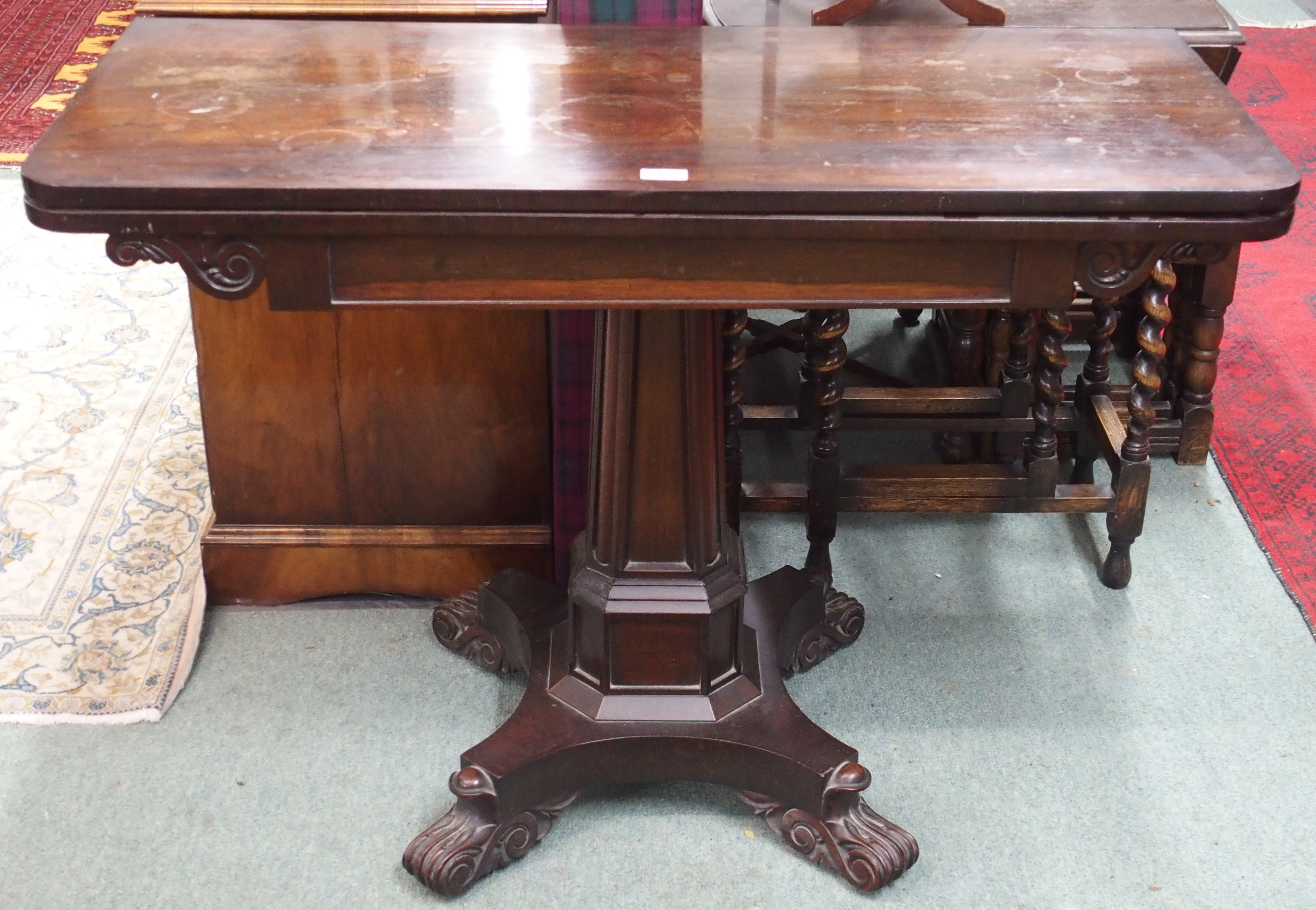 A Victorian rosewood fold over tea table on pedestal base Condition Report: Available upon request