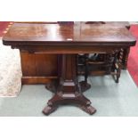 A Victorian rosewood fold over tea table on pedestal base Condition Report: Available upon request