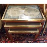 A nest of brass tables with map insets Condition Report: Available upon request