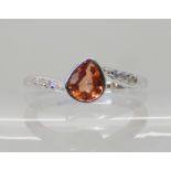 A 9ct white gold padparadscha colour sapphire and diamond ring, size N1/2, weight 2.9gms. With a