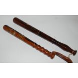 Two painted hardwood truncheons, 46cm and smaller (2) Condition Report: Available upon request