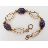 A 9ct gold Ortak amethyst and lover's knot bracelet length 19.5cm, weight 12.6gms Condition