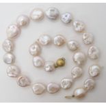 A string of button shaped baroque pearls with a 9ct gold clasp length 46.5cm, weight 58gms Condition