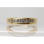 A bright yellow metal ring set with princess cut diamonds with an estimated approx total of 0.60cts,