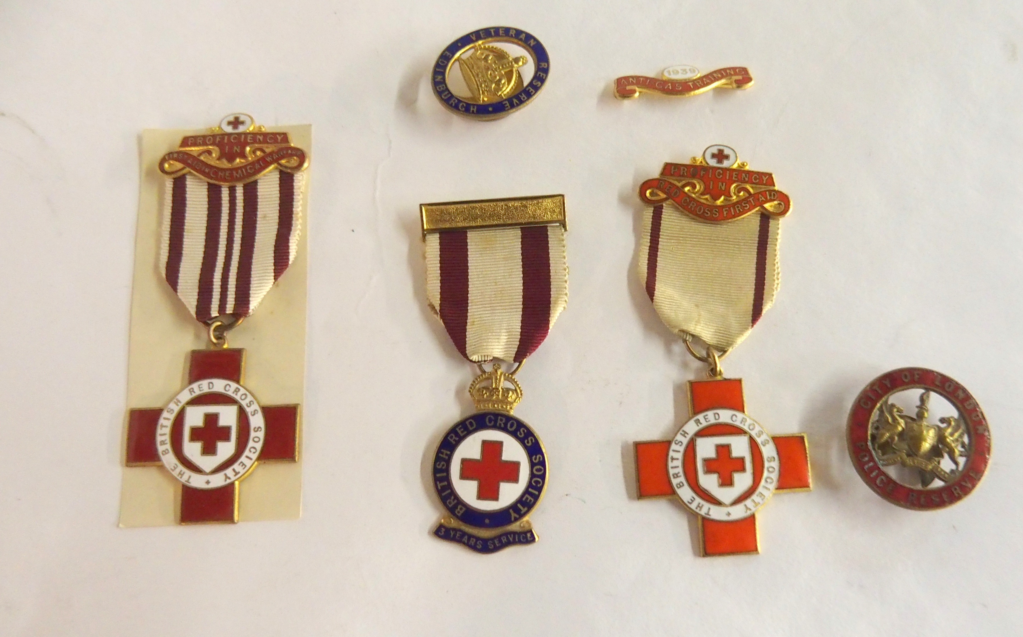 Three enamel British Red Cross nursing medals to J.T. Waddell with box and collection of other