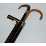 A silver-tipped walking cane, another with animal horn handle, a Chinese silver-topped walking