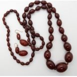 A string of cherry amber coloured beads with matching earrings, weight combined 67gms Condition