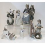 Three Llado figures including a couple, a girl at an easel, and a dog together with three Nao